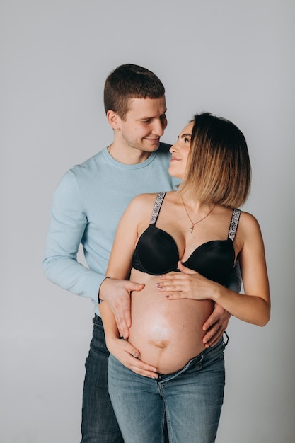 Young pregnant woman with her husband at home