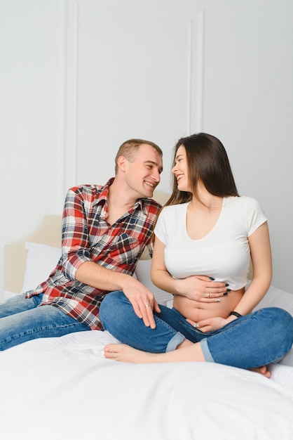 Young pregnant woman with husband posing