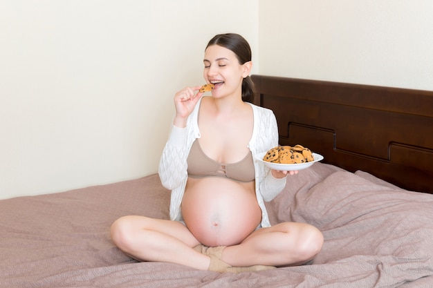 Young pregnant woman with sweets