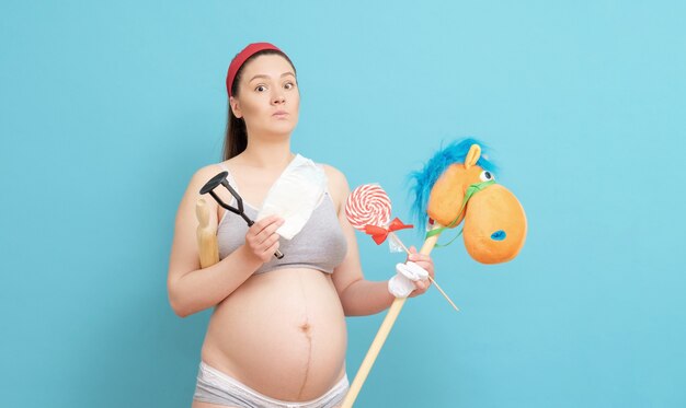 Young pregnant woman with toys