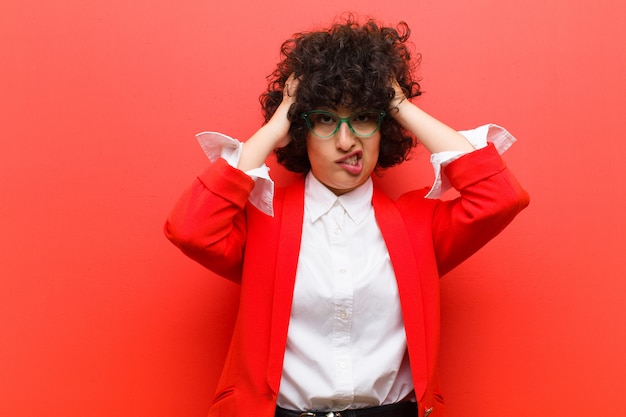 Young pretty afro woman feeling frustrated and annoyed, sick and tired of failure, fed-up with dull, boring tasks