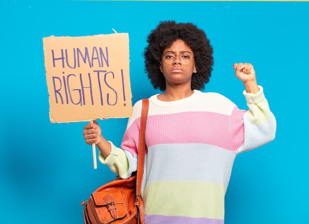 Young Pretty afro woman protesting with human rights banner