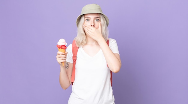 young pretty albino woman covering mouth with hands with a shocked .summer concept