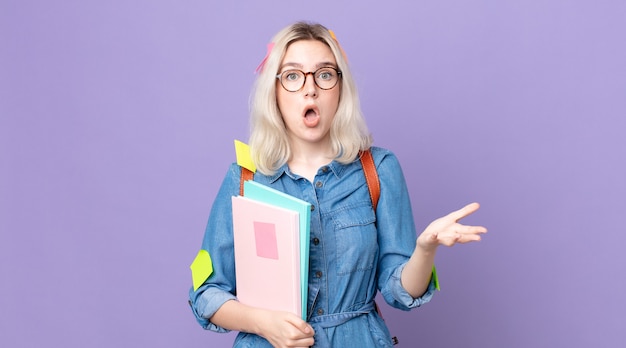 Young pretty albino woman feeling extremely shocked and surprised. student concept