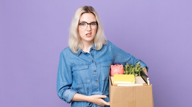 Young pretty albino woman feeling puzzled and confused. dismissal concept