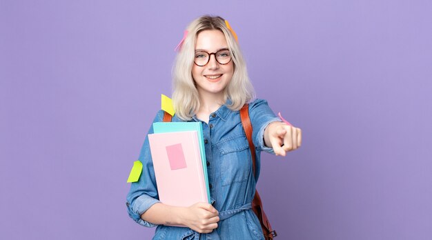 Young pretty albino woman pointing at camera choosing you. student concept