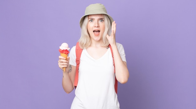 Young pretty albino woman screaming with hands up in the air .summer concept