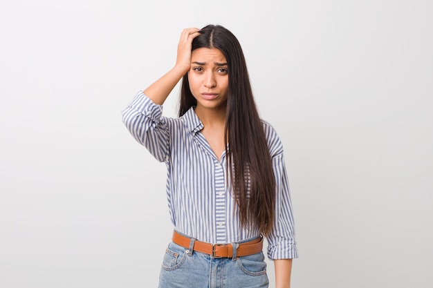 Young pretty arab woman being shocked, she has remembered important meeting.