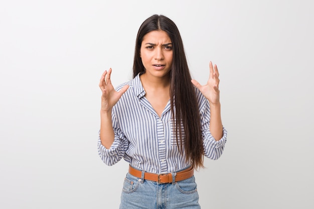 Young pretty arab woman screaming with rage.