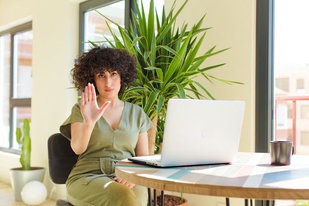 Young pretty arab woman with a laptop on a table