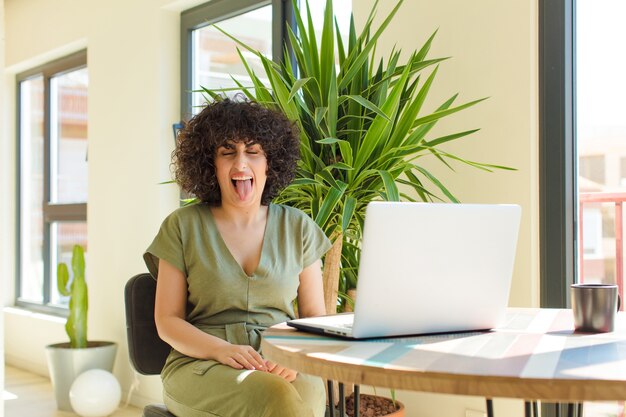 Photo young pretty arab woman with a laptop on a table