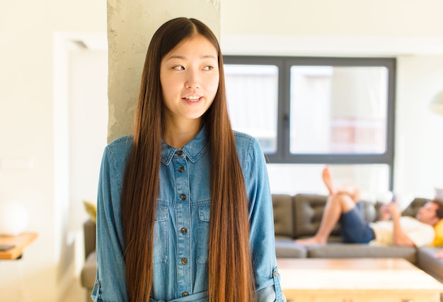 Young pretty asian woman feeling shocked