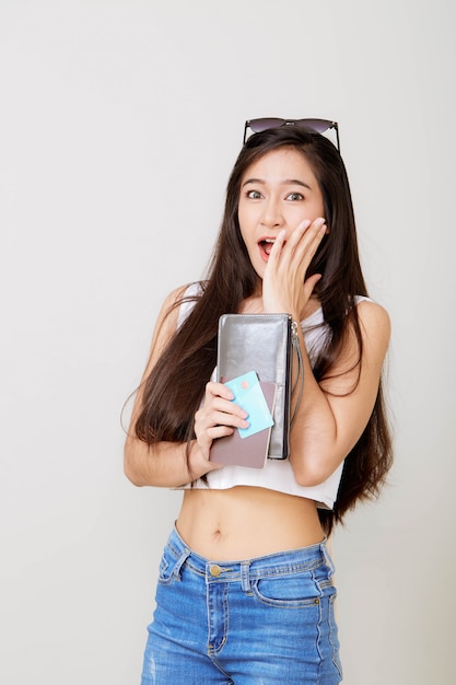 Young pretty Asian woman holding wallet with credit card