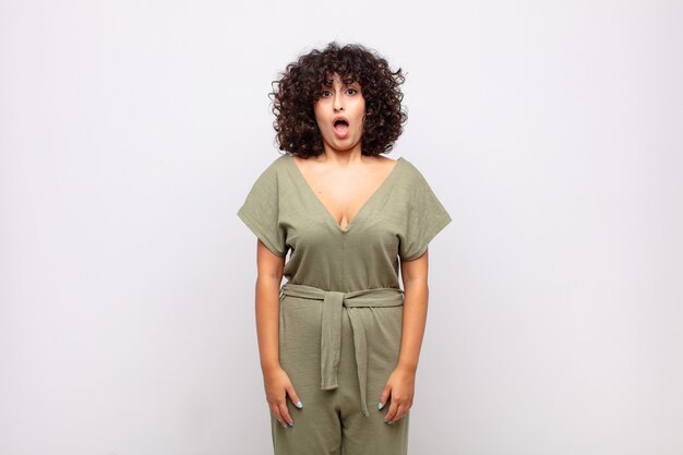 young pretty astonished woman with curly hair