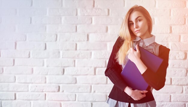 Young pretty blonde girl student before class