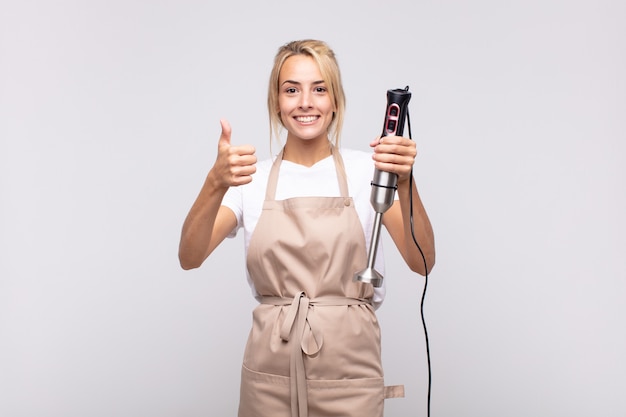 young pretty blonde woman baker with a mixer