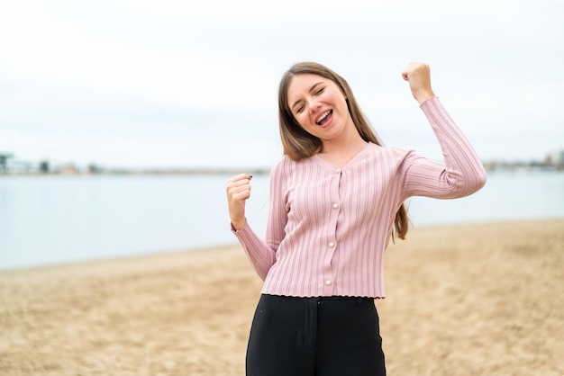 Young pretty blonde woman celebrating a victory