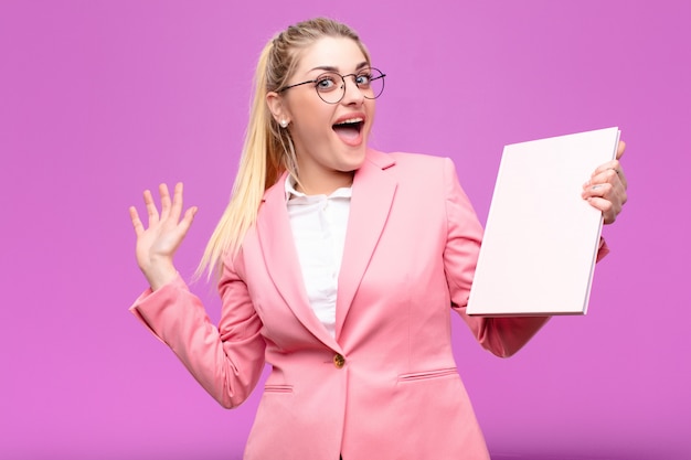 Young pretty blonde woman holding books