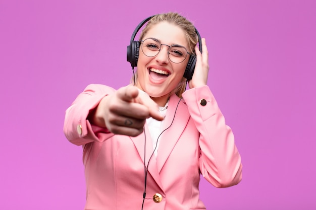 Young pretty blonde woman listening music with headphones