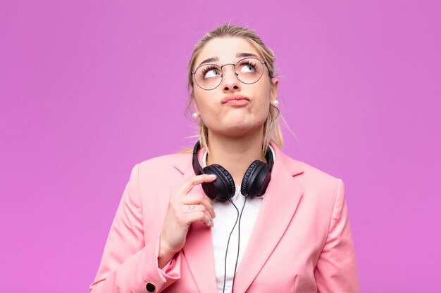 Young pretty blonde woman listening music with headphones