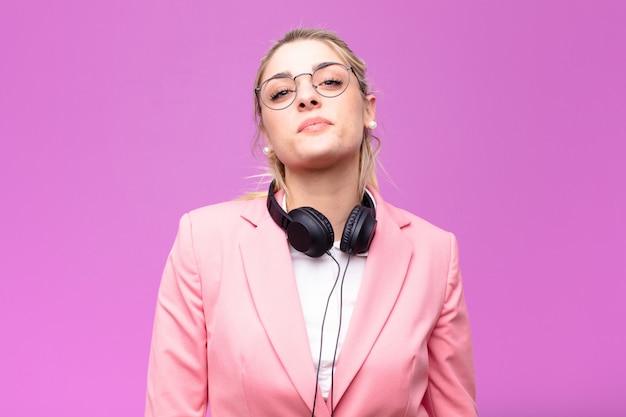 Young pretty blonde woman listening music with headphones