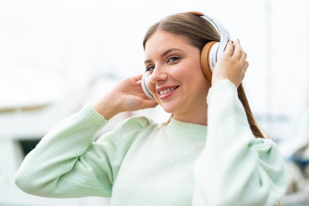 Young pretty blonde woman listening music