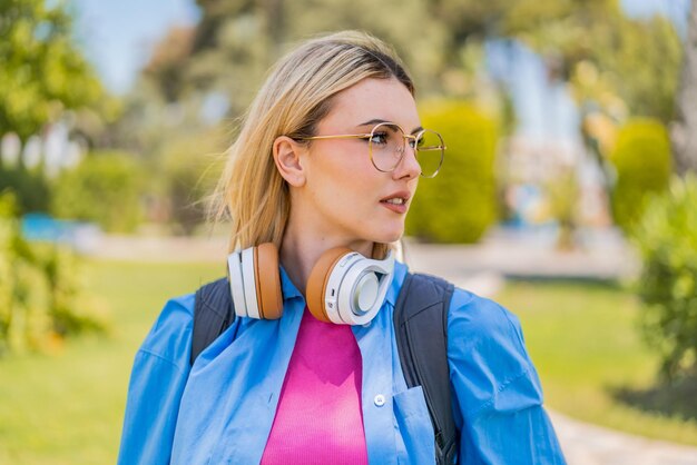 Young pretty blonde woman at outdoors portrait