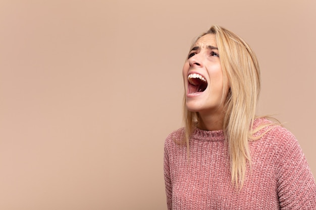 young pretty blonde woman screaming