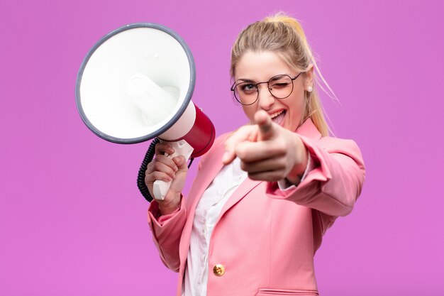 Young pretty blonde woman with a megaphone