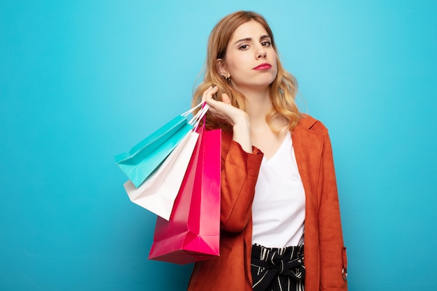 Young pretty blonde woman with shopping bags