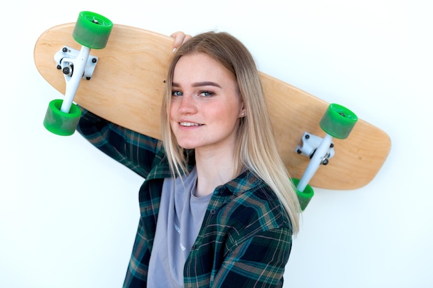 a young pretty blondie lady with skate board at the street