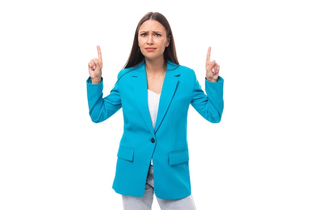 Young pretty brunette secretary woman in blue jacket talking about news gesturing on isolated white