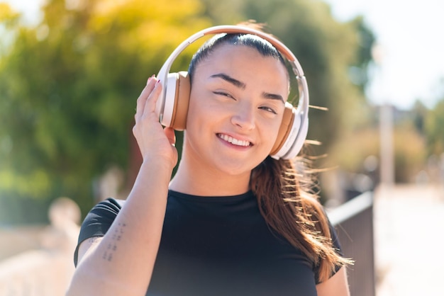 Young pretty brunette woman listening music