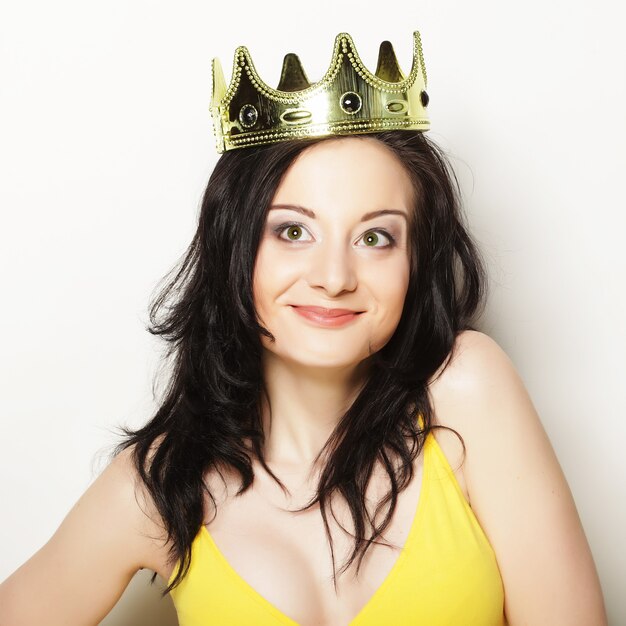 Young pretty brunette woman wearing crown