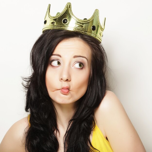 Young pretty brunette woman wearing crown