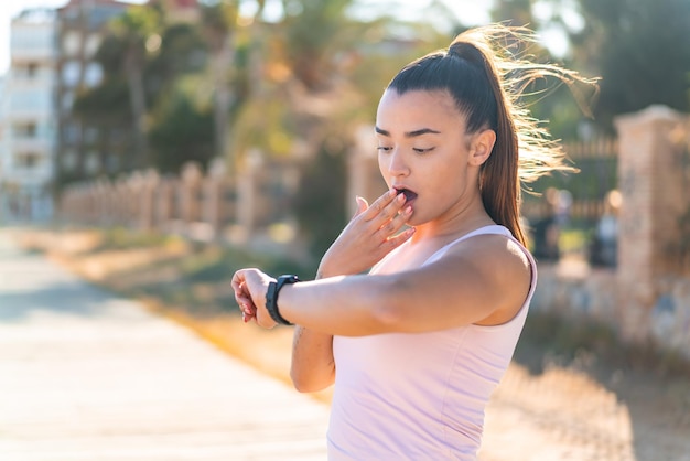 Young pretty brunette woman with sport watch