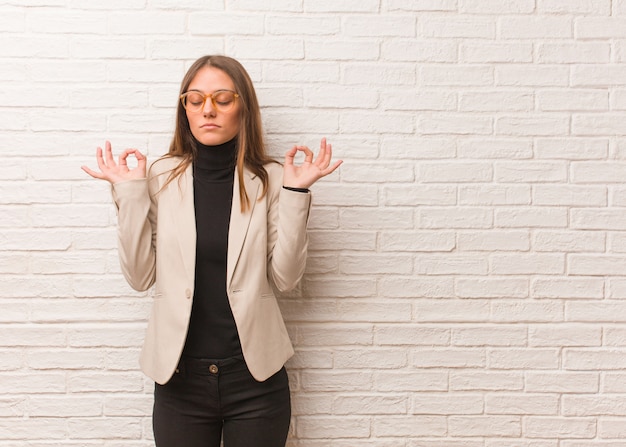 Young pretty business entrepreneur woman performing yoga