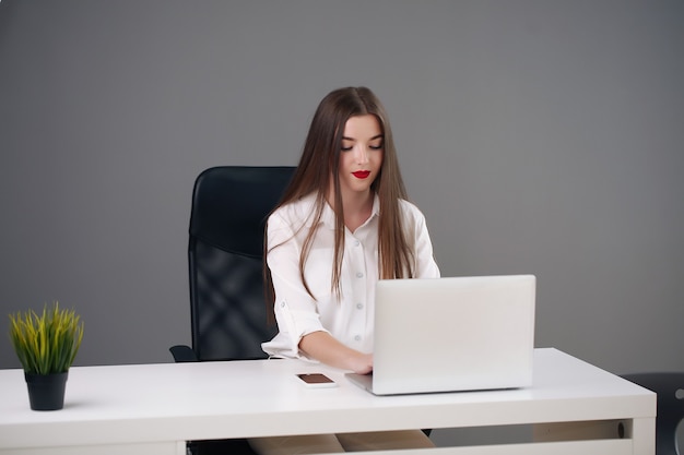 Young pretty businesswoman at office