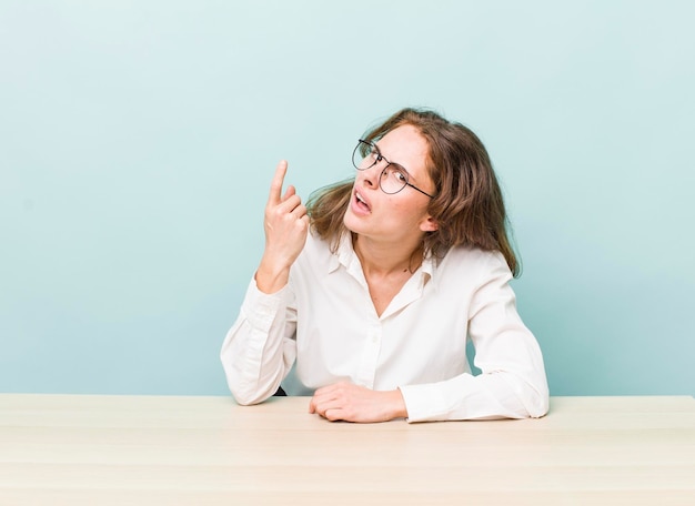 Young pretty businesswoman sitting with a table