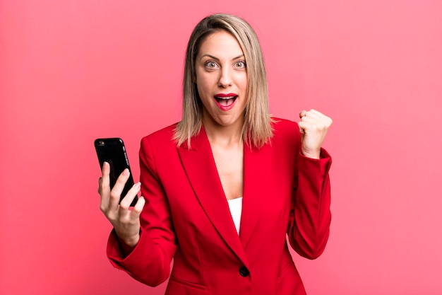 Young pretty businesswoman using her smart phone