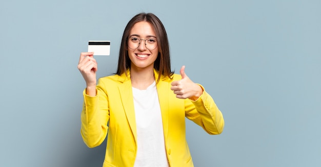 Young pretty businesswoman with a credit card