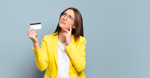 Young pretty businesswoman with a credit card