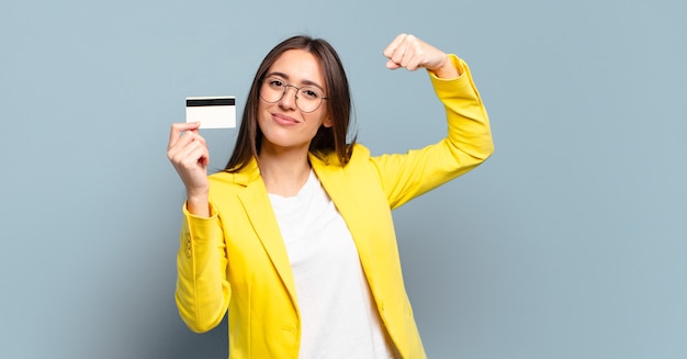 Young pretty businesswoman with a credit card