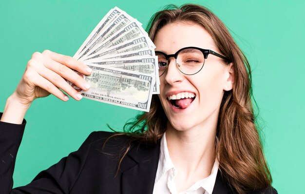 Young pretty businesswoman with dollar banknotes