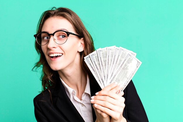 Young pretty businesswoman with dollar banknotes