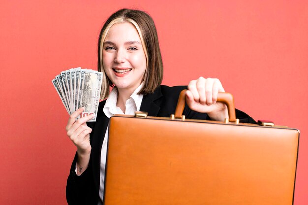 Young pretty businesswoman with a leather suitcase