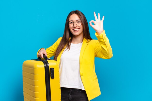 Young pretty businesswoman with a suitcase