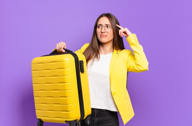 Young pretty businesswoman with a suitcase