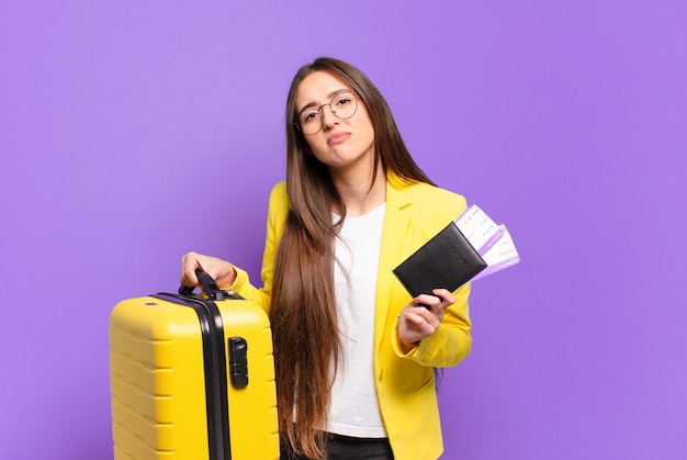 Young pretty businesswoman with a suitcase