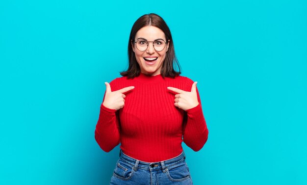 Young pretty casual woman feeling happy surprised and proud pointing to self with an excited amazed look